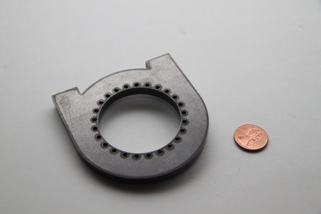 Portland laser cutting service image of product next to penny to show scale